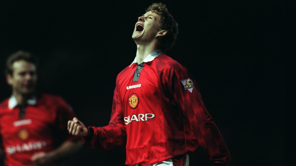 Ole Gunnar Solskjaer in a Manchester United shirt during his playing days, highlighting his long-standing connection to the club.