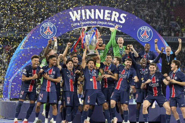 Paris Saint-Germain players celebrate with the Champions League trophy after winning the final