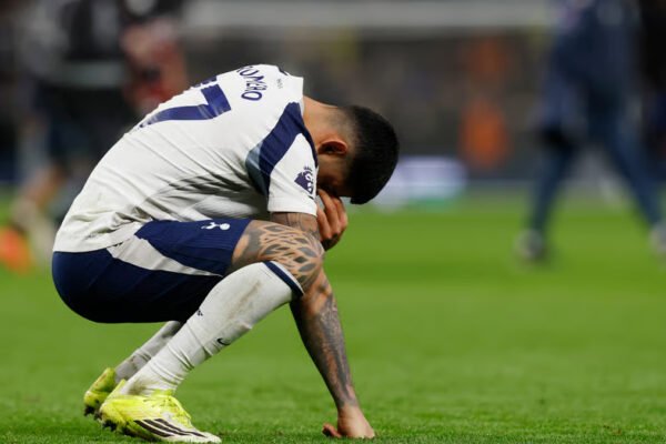 Tottenham player crouches on the pitch with head down