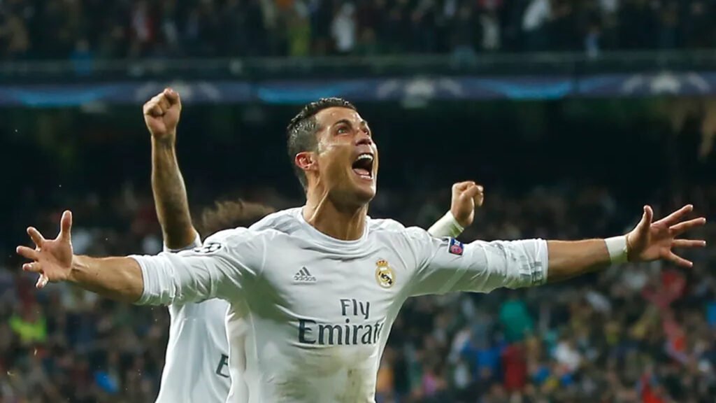 Cristiano Ronaldo celebrates in Real Madrid shirt with arms outstretched