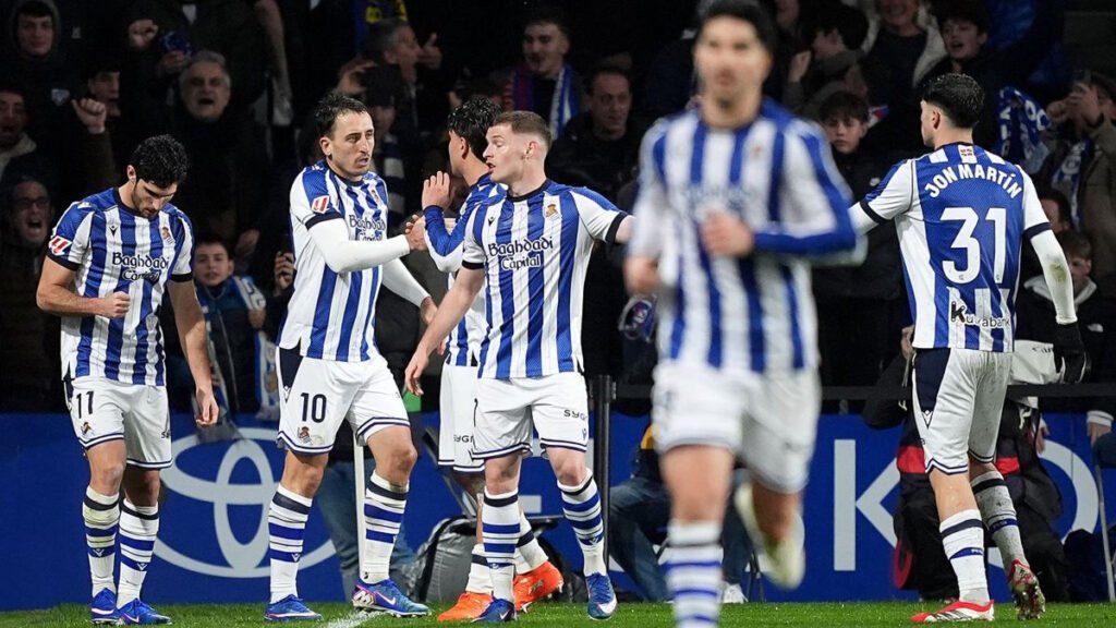 Mikel Oyarzabal celebrates after scoring as teammates run toward him