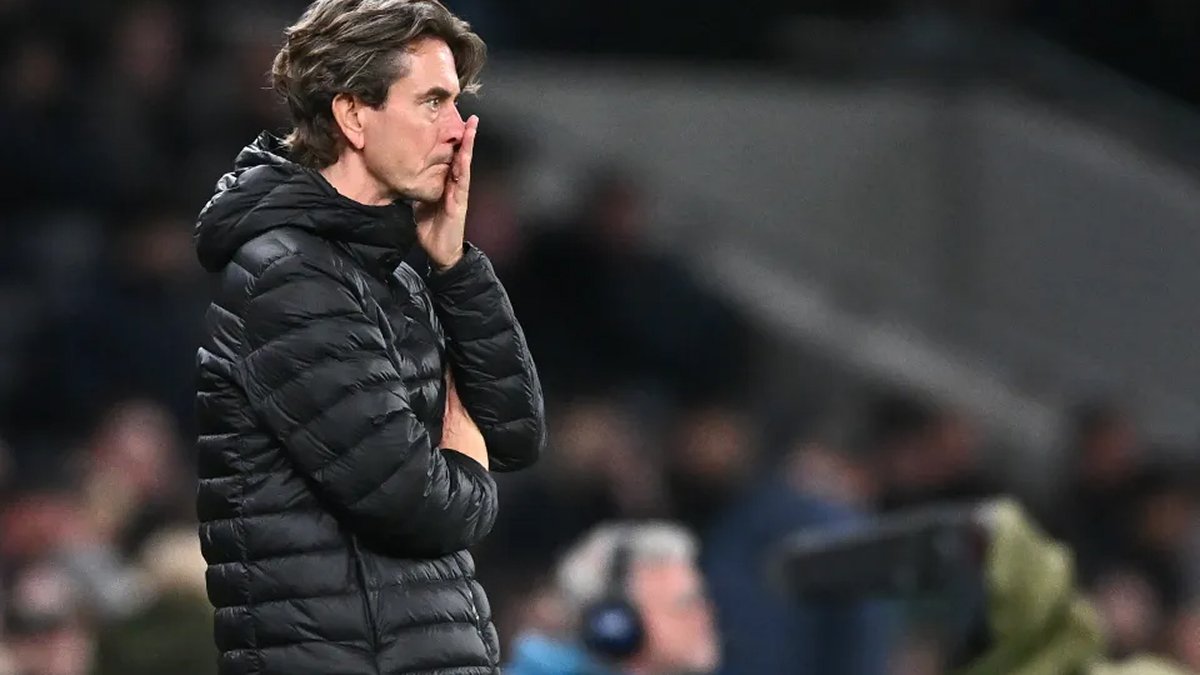 Thomas Frank watches the match from the touchline in a padded coat