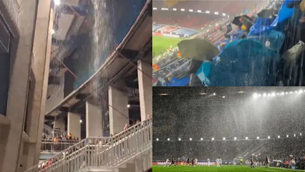 Rainwater pours through stadium structure as media and seats get soaked