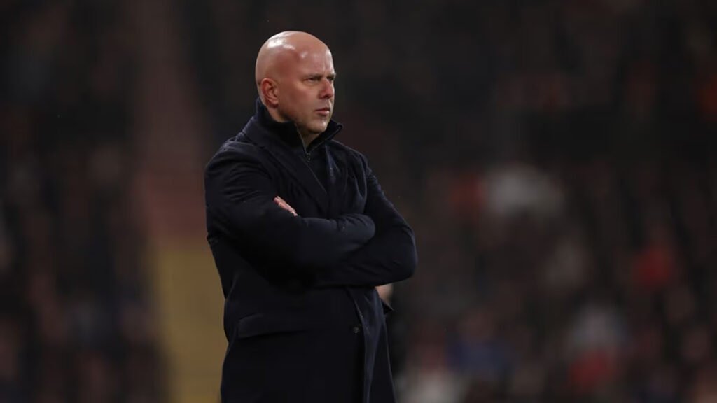 Arne Slot watches from the sideline during a Premier League game