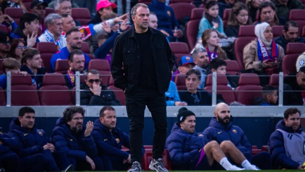 Hansi Flick gives instructions on the touchline during stormy conditions