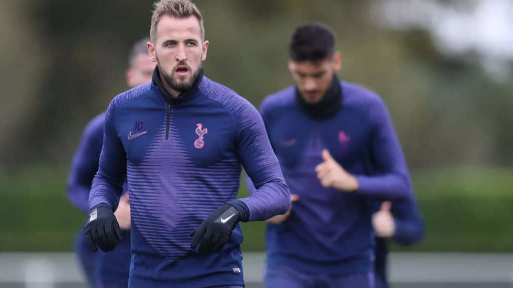 Harry Kane focused during a Tottenham training session, concentrating on ball control and drills.