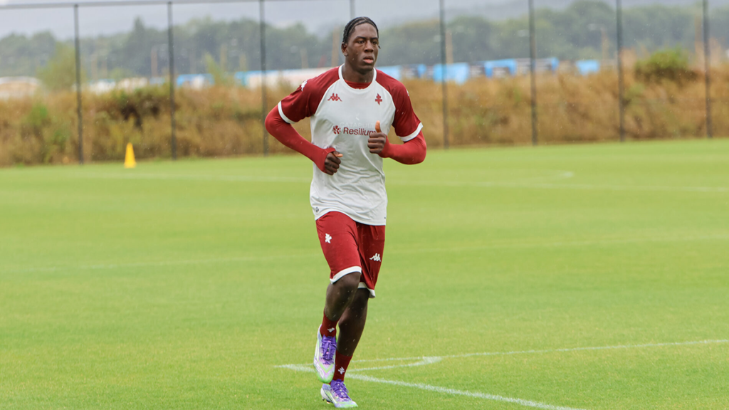 Brian Madjo in FC Metz training kit, practicing ball control and drills on the pitch.