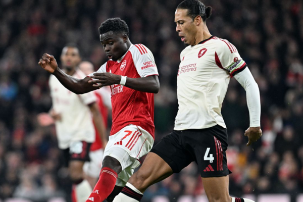 Arsenal and Liverpool players battling for possession during a tense Premier League clash