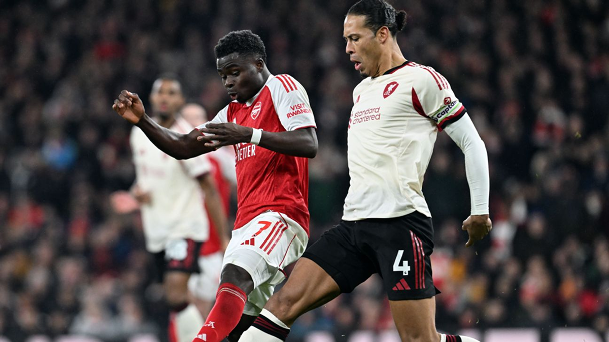 Arsenal and Liverpool players battling for possession during a tense Premier League clash