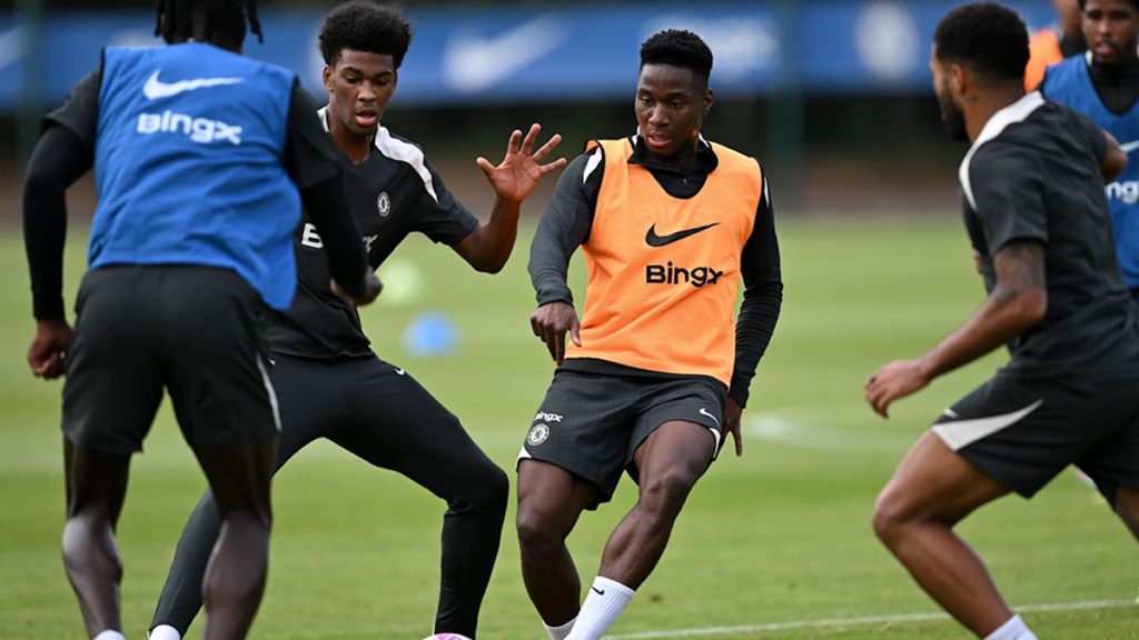 Chelsea youth players in training session, developing skills on the pitch