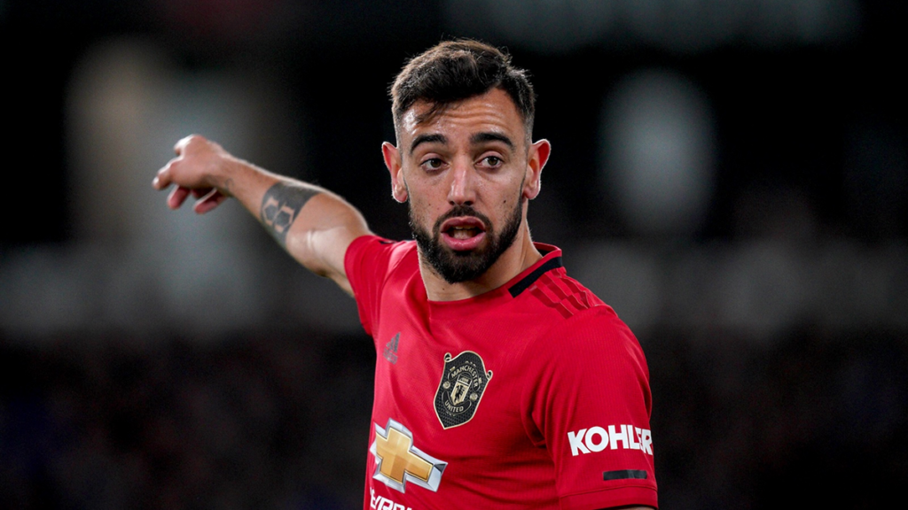 Close-up of Bruno Fernandes with a concerned expression on the pitch, Manchester United match in focus.