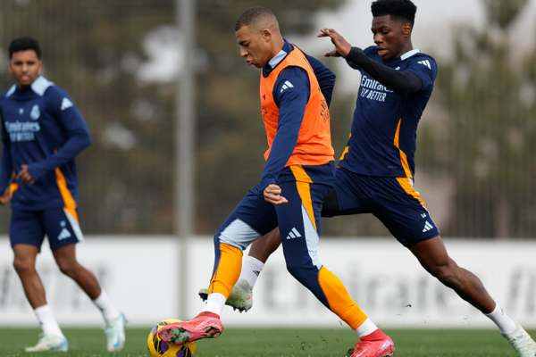 Kylian Mbappé intensely focused on the ball during a Real Madrid training session