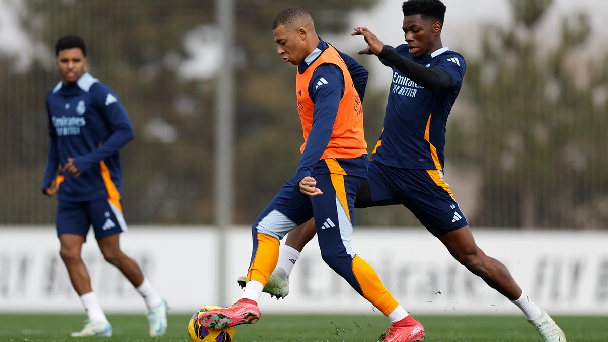 Kylian Mbappé intensely focused on the ball during a Real Madrid training session