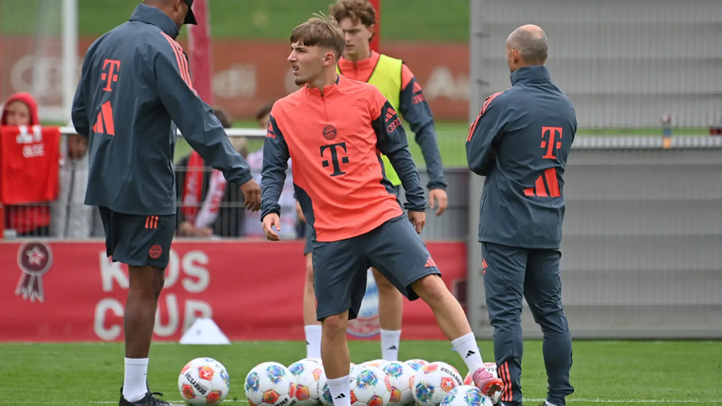 Lennart Karl concentrating on ball control during Bayern Munich training session, showing skill and focus.