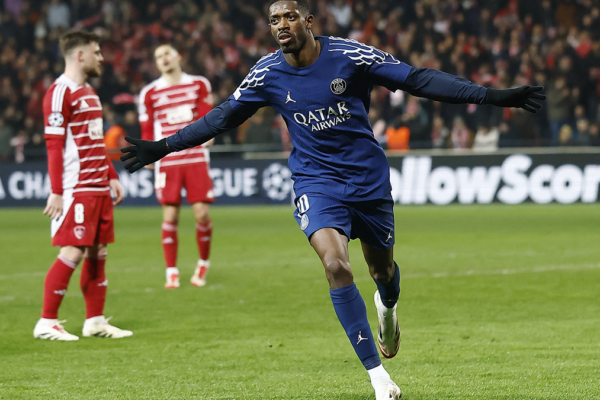 Ousmane Dembélé celebrating a goal during a PSG match, full of energy and excitement