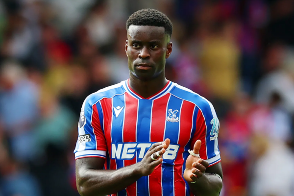 Close-up of Marc Guéhi concentrating during a match, focused on the ball and defensive positioning.
