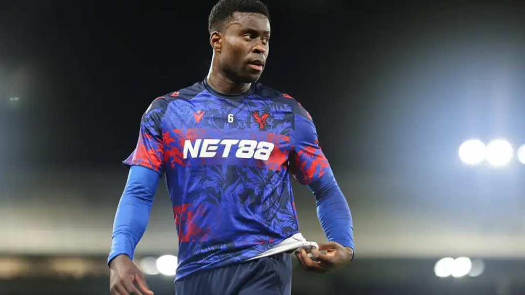 Marc Guéhi in training, practicing defensive drills with teammates, focused and determined.