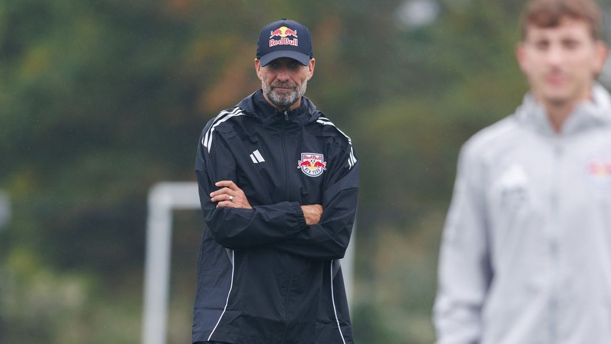 Jürgen Klopp standing on the side during an RB Leipzig training session, focused on the players