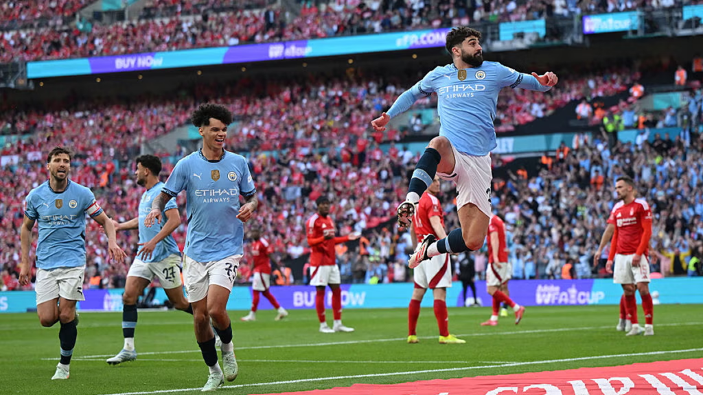 Manchester City players celebrating a goal during an FA Cup match