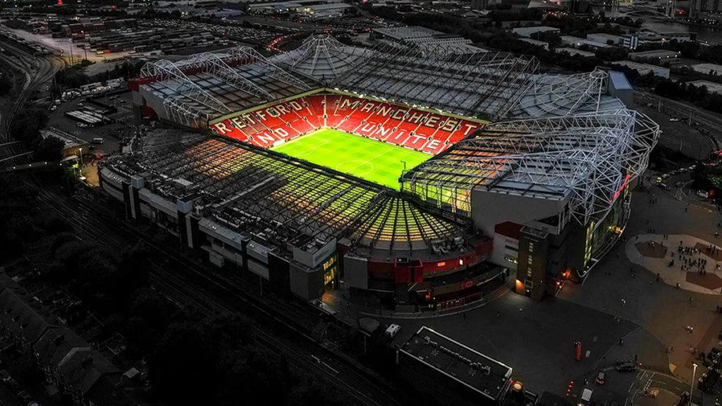 An aerial night view of Old Trafford, symbolising Manchester United’s search for direction during a period of transition.
