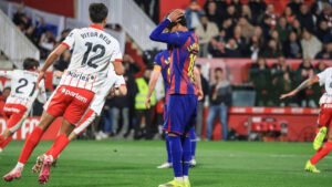Barcelona players react after a late goal during an away league match.