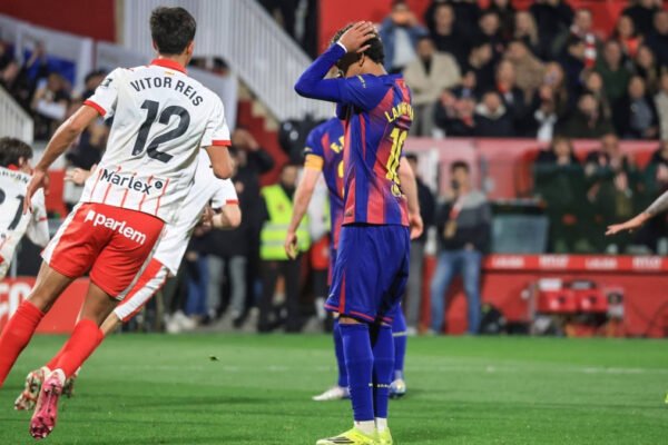Barcelona players react after a late goal during an away league match.