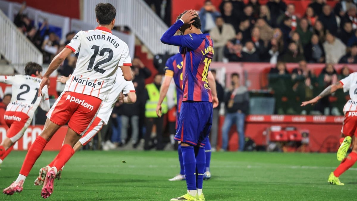 Barcelona players react after a late goal during an away league match.