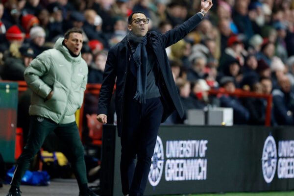 Liam Rosenior stands on the touchline during a night match