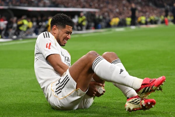 Bellingham walks off holding his left thigh during a match