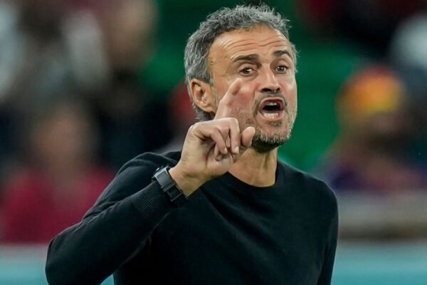 Luis Enrique gestures from the touchline during a PSG match.