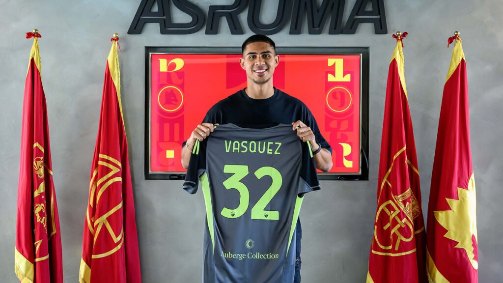 Devis Vasquez holds a Roma shirt during his presentation after joining the club.