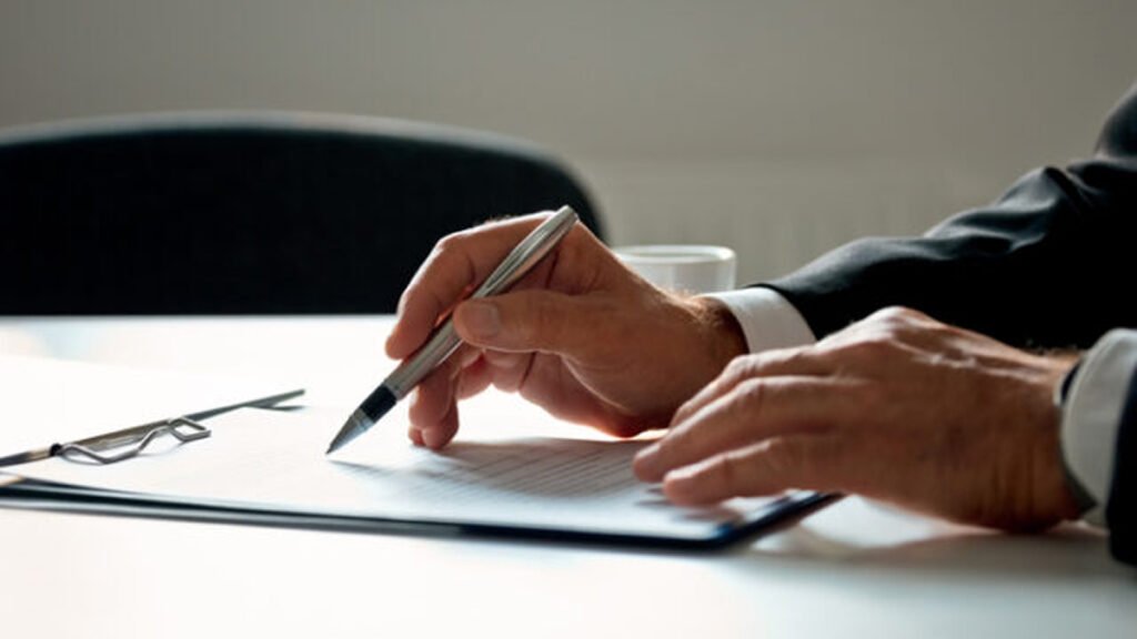 Close-up of a contract on a desk with a pen