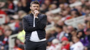 Michael Carrick watches from the touchline during a Manchester United match.