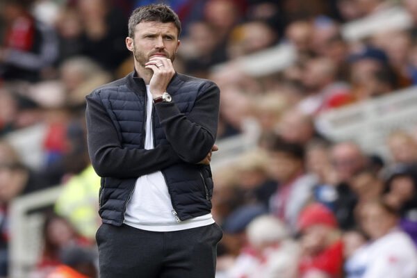 Michael Carrick watches from the touchline during a Manchester United match.