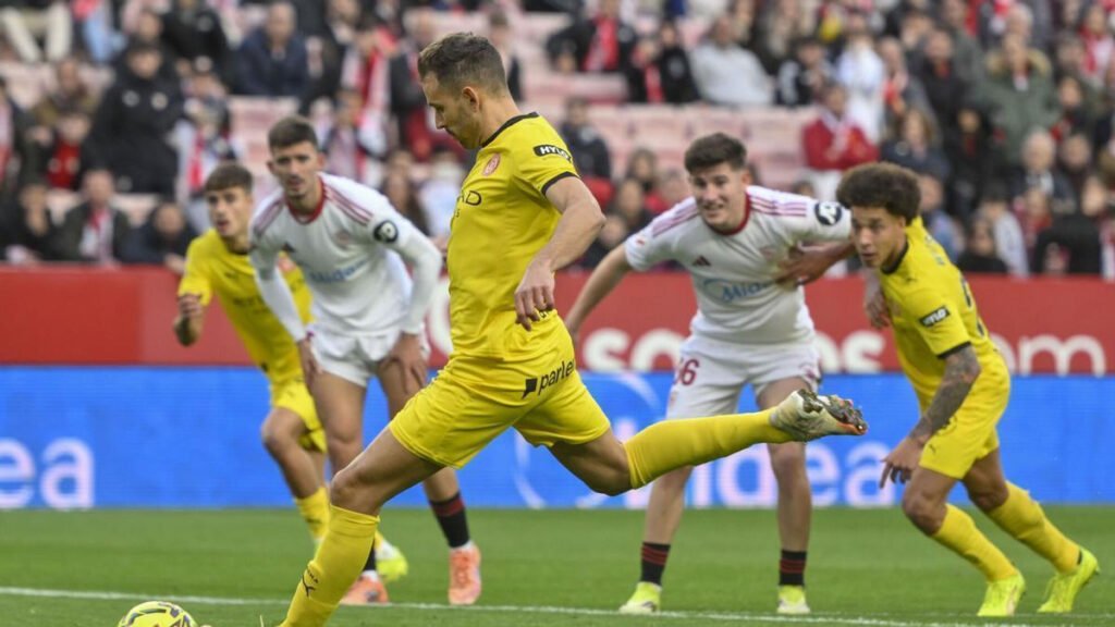 Sevilla players regroup as the crowd reacts after a late penalty save