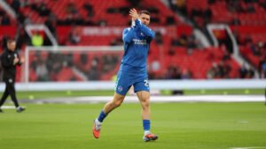 James Milner warms up on the touchline in Brighton colours before coming on as a substitute.