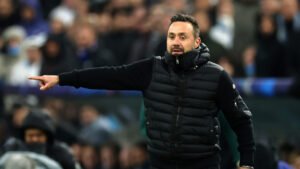 Roberto De Zerbi gestures on the Marseille touchline during a match.