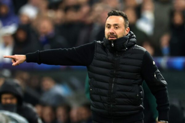 Roberto De Zerbi gestures on the Marseille touchline during a match.